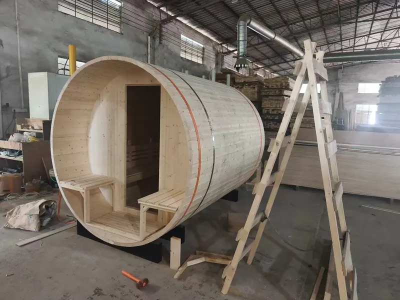Barrel sauna under assembly, with interior lining and benches fitted