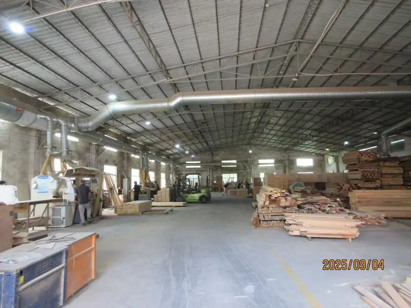 Main production hall with milling machinery, timber in store and panel stacks on the floor