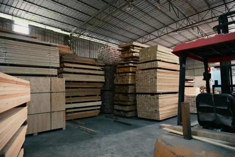 Forklift working between timber stacks in the storage hall